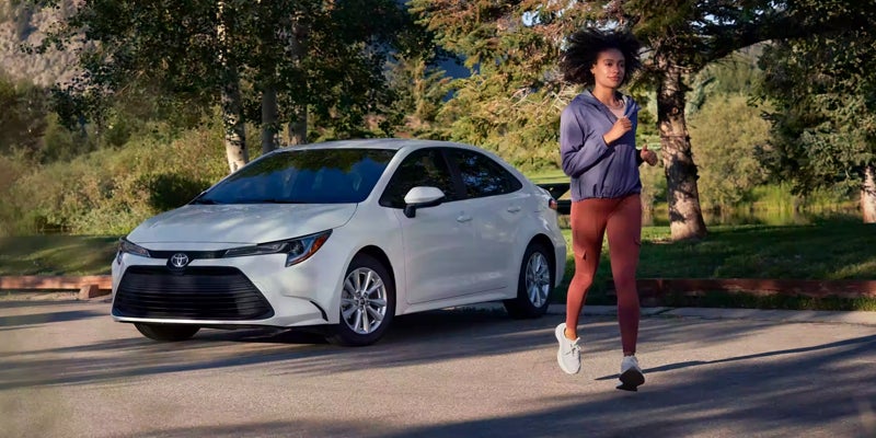 A jogger getting ready for a run after parking their 2024 Toyota Corolla near Akron, OH 
