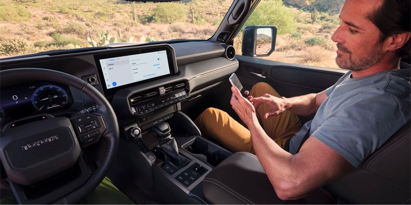 A passenger connecting wirelessly to the 2024 Toyota Land Cruiser in Akron, OH