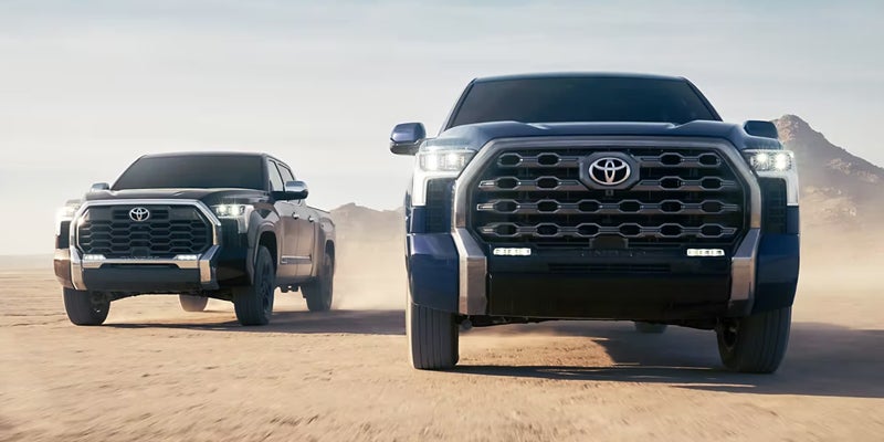 Two 2024 Toyota Tundra trucks driving off-road near Akron, OH